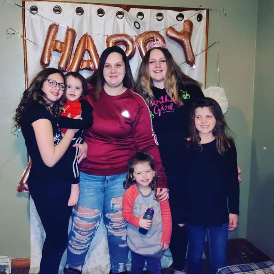 a family poses for a photo in front of part decorations